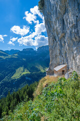 Fototapeta na wymiar House built on narrow rock on the way to Äscher, Schwende-Rüte, Canton Appenzell-Innerrohden, Switzerland