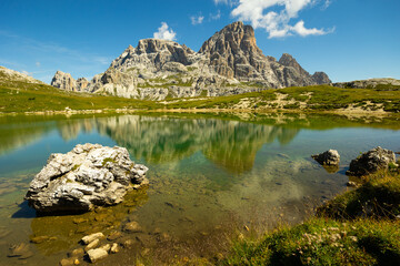 Spectacular scene of small serene natural lakes Bodenseen under summer sun surrounded by greenery and rocky mountains in Sexten Dolomites in South Tyrol, Italy