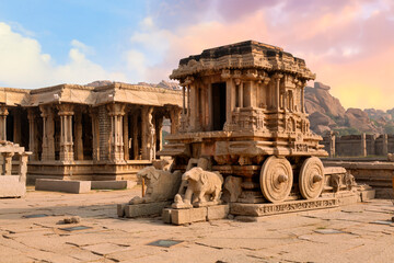Famous ancient stone chariot of Hampi in closeup view with other architecture ruins at Karnataka,...