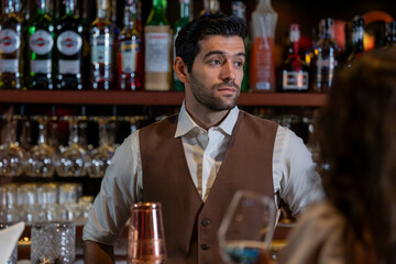 Man bartender is making a drink and dancing at bar. Dance party with group people dancing . Women and men have fun and drinking martini cocktail in night club.