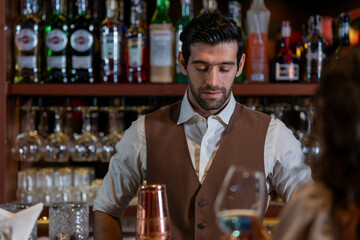 Man bartender is making a drink and dancing at bar. Dance party with group people dancing . Women and men have fun and drinking martini cocktail in night club.