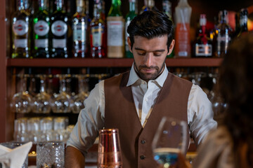 Man bartender is making a drink and dancing at bar. Dance party with group people dancing . Women and men have fun and drinking martini cocktail in night club.