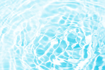 Blue water surface texture with ripples, splashes, and bubbles. Abstract summer banner background Water waves in sunlight with copy space cosmetic moisturizer micellar toner emulsion. Blue water wave