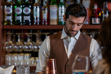 Man bartender is making a drink and dancing at bar. Dance party with group people dancing . Women and men have fun and drinking martini cocktail in night club.