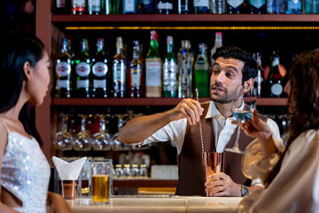 two girls in sexy dress are drinking and dancing at bar. Dance party with group people dancing . Women and men have fun and drinking martini cocktail in night club.