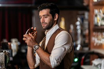 Man bartender is making a drink and dancing at bar. Dance party with group people dancing . Women and men have fun and drinking martini cocktail in night club.