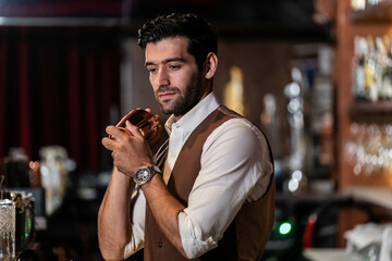 Man bartender is making a drink and dancing at bar. Dance party with group people dancing . Women and men have fun and drinking martini cocktail in night club.