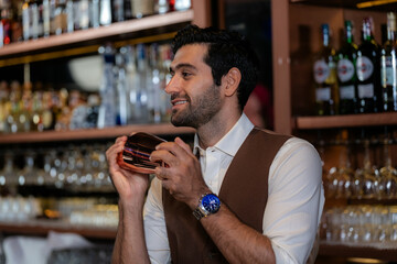 Man bartender is making a drink and dancing at bar. Dance party with group people dancing . Women and men have fun and drinking martini cocktail in night club.