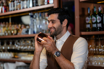 Man bartender is making a drink and dancing at bar. Dance party with group people dancing . Women and men have fun and drinking martini cocktail in night club.