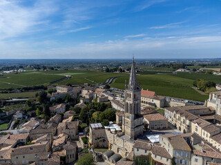 Obraz premium Aerial views of green vineyards, old houses and streets of medieval town St. Emilion, production of red Bordeaux wine on cru class vineyards in Saint-Emilion wine making region, France, Bordeaux