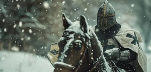 Fotobehang A Teutonic Knight on horseback rides through a snowy landscape his breath visible in the cold air. © Justlight