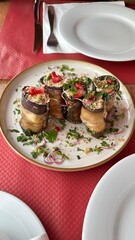 Having dinner with eggplant rolls with walnuts