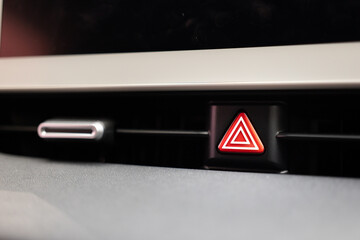 Emergency stop button in the car. Car emergency warning light button in front car console.