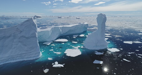 Global issue of climate change and melting icebergs on South Pole aerial. Uninhabited Antarctica environment and nature scape of seas and land in snow and ice at sun winter day. Warming clime