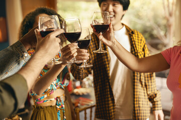 Close up of happy friends drinking wine and enjoying time together at holiday party at home