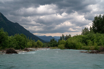 Fototapeta premium View of the Psysh riverbed in the northern foothills of the Caucasus Mountains near the village of Arkhyz on a sunny summer day, Karachay-Cherkessia, Russia