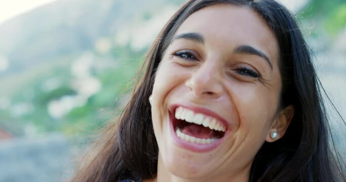 Face, woman and laughing on summer vacation in nature, relax and comic by outdoor trip by mountain. Young lady, happy and portrait in greece for funny joke, sunshine and wellness on travel journey