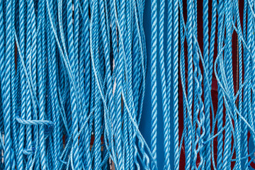 background close up of industrial blue ropes hanging vertically - obrazy, fototapety, plakaty