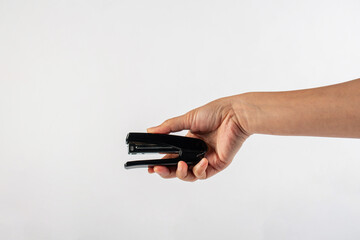 Black stapler in hand isolated on white background