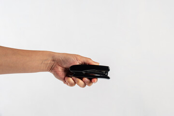 Black stapler in hand isolated on white background
