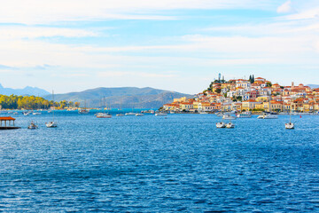 Fototapeta na wymiar The island and town of Poros, Greece, a small Greek island in the Saronic Gulf chain of islands in Southern Greece, just off the mainland Peloponnese region.