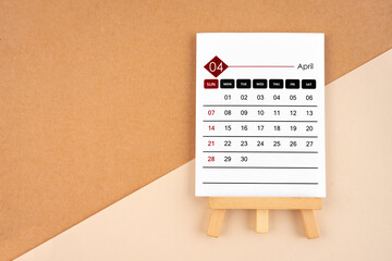 2024 April calendar page on brown background.