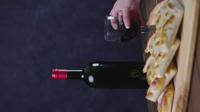 Chilean wine glasses and bottle and empanadas variety. Chile Food background. Fresh ingredients on wood. Selective Focus.