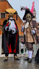 Venice Carnival. People in Venetian carnival masks and costumes on streets of Venice, Italy, Europe February 10, 2024