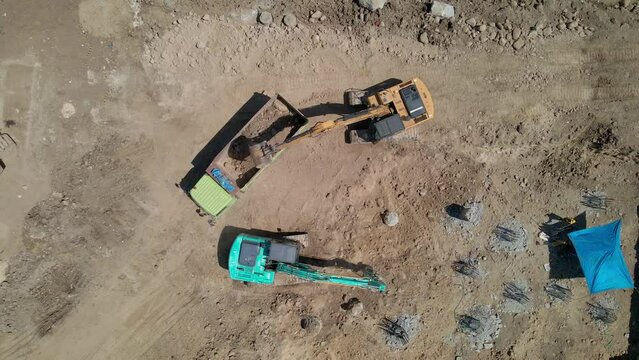 Aerial view of road construction activities using heavy machinery and equipment