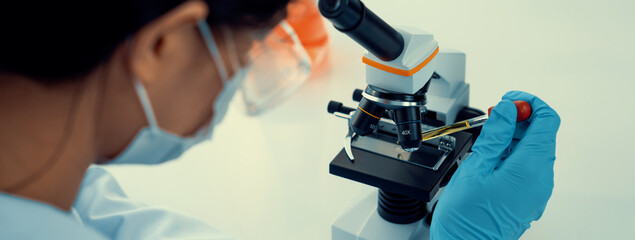 Laboratory researcher develop new medicine or cure using microscope. Technological advance of...