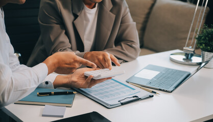 Business team working with new startup project plan and discussion information for financial strategy with laptop and digital tablet in a modern business lounge.