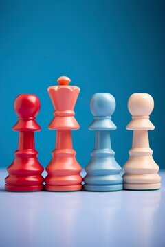 Close-up of colorful chess pawns on a blue background, each piece conveys a sense of fun, social inclusion and diversity. Pawns in the concept of equity and inclusion.