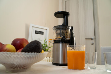 Cold pressed juicer with finished product healthy drink from raw fruit 