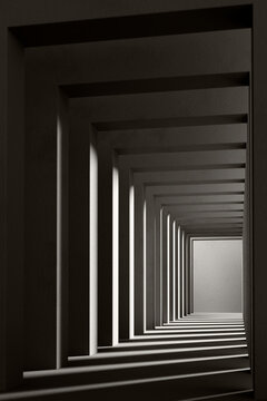 A black and white background with light coming through the building structure. 3d rendering.