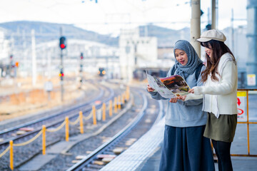 woman girl tourist Two Asian friends but different religions, one of whom is a Muslim girl. Looking...