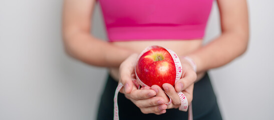 woman hand hold red Apple, happy female fitness choose fruit is Healthy food. Dieting control,...