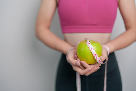 woman hand hold green Apple, happy female fitness choose fruit is Healthy food. Dieting control, Weight loss, Obesity, eating lifestyle and nutrition concepts