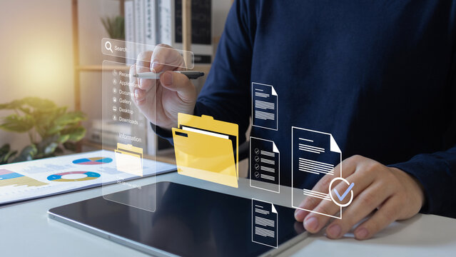 Document Management System (DMS),Businessman using a laptop searching folder and managing files paperwork.Software for archiving,share online database server, administration employee in enterprise.