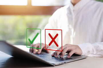 check right and wrong marks on a laptop. concept decide to choose vote. yes or no decisions, and business options for difficult situations in dilemma. true and false symbols agreeing - obrazy, fototapety, plakaty