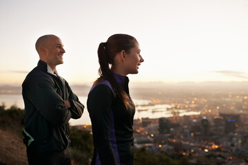 Happy couple, fitness and vision with city on mountain for dream, ambition or outdoor workout in nature. Young man and woman with smile for view of town in exercise or training together on cliff