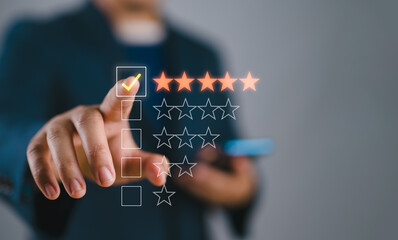 Hand touching and doing mark to five yellow stars on black background, the best customer satisfaction and evaluation for good quality product and service.