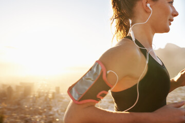 Woman, running and listening to music with earphones for workout, training or outdoor exercise....