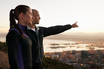 Exercise, nature and couple with hand pointing to sunset, city view or fitness vision. Health, training and sports people outside planning running route, workout or speed target together at sunrise - obrazy, fototapety, plakaty