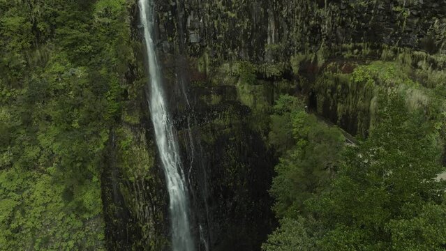 Drone shot moving up to the top of a waterfall