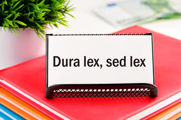 Dura Lex Sed Lex. A Latin phrase meaning The law is harsh, but it is (still) the law. on white...