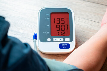 man check blood pressure monitor and heart rate monitor with digital pressure gauge. Health care...