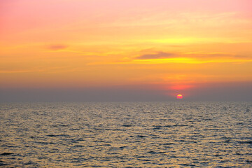 Sea view for summer vacation concept Nature of the summer beach and sea with soft sunlight. hitting the sand The sea sparkles against the sunset sky.	
