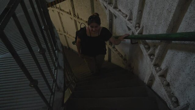 A woman ascends the stairs of the Stilo lighthouse in Stilo, Poland. The shot is captured from the top of the stairs.