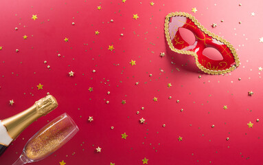Happy Purim carnival decoration concept made from golden mask star and glitter on red background. (Happy Purim in Hebrew, jewish holiday celebrate)