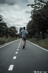 A man  jogging in the city center park cardio workout, running.  Health and Lifestyle in big city life concept.